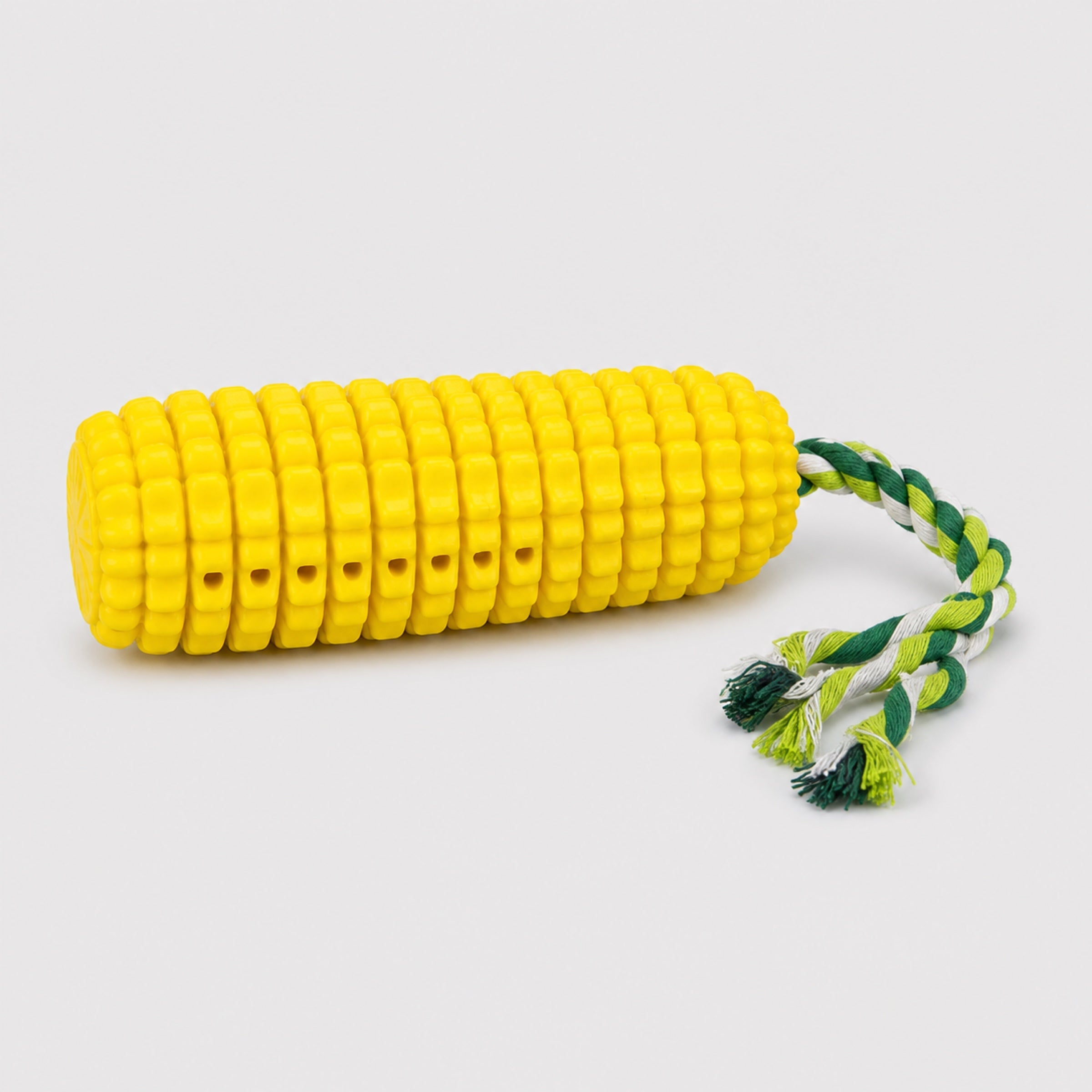 Corn dog chew toy with braided rope on light grey studio background