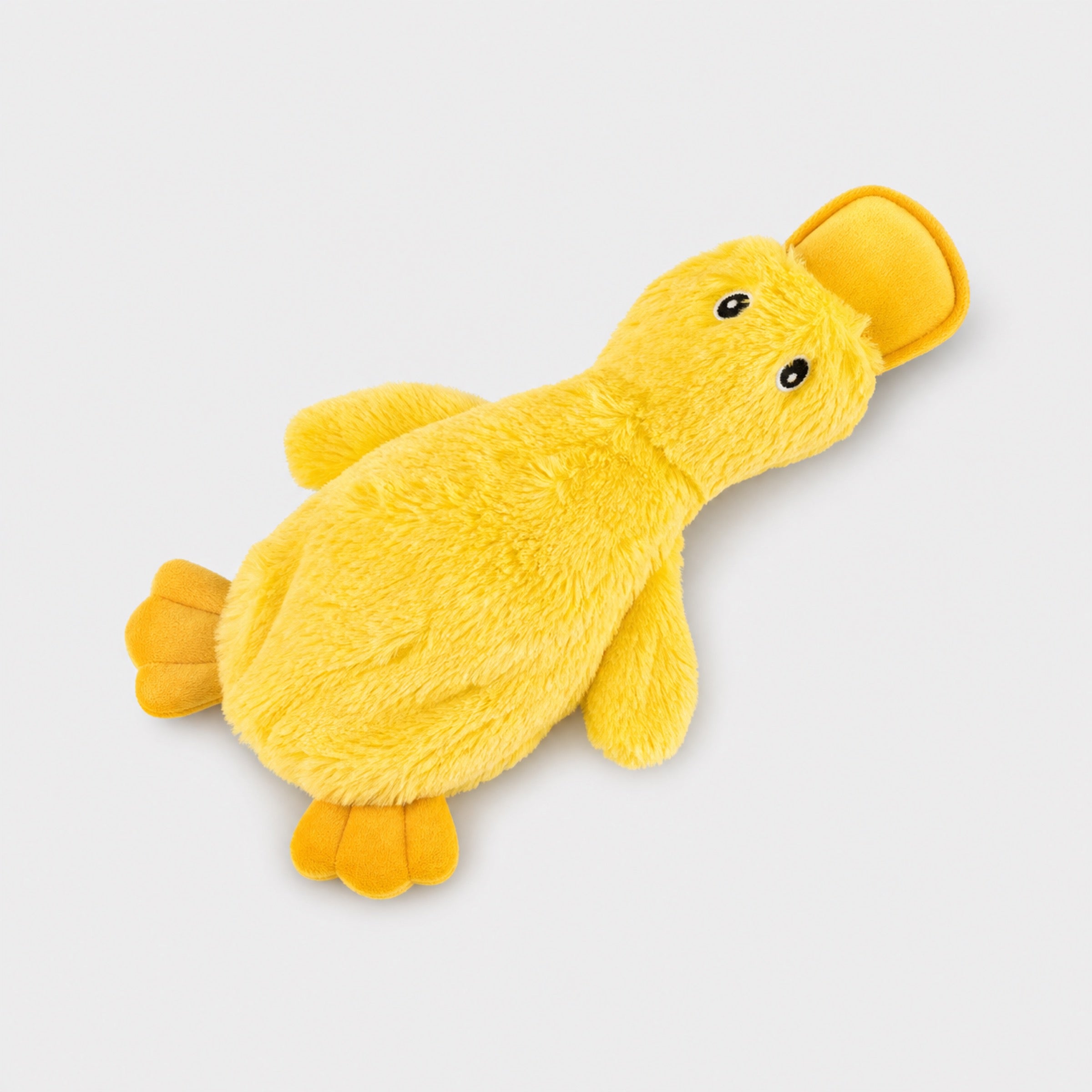 Yellow duck plush squeaky dog chew toy on light grey background