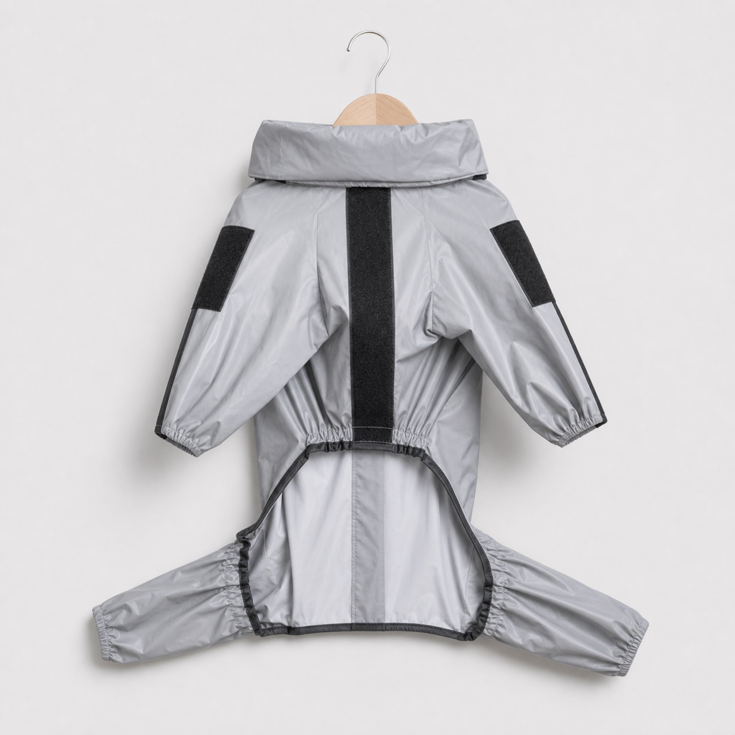Gray reflective waterproof dog raincoat centered on light grey studio background
